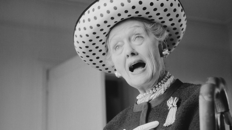 Hedda Hopper in polka dot hat speaking