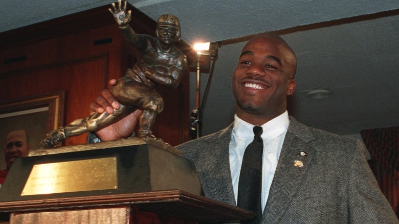 Salaam holding Heisman smiling