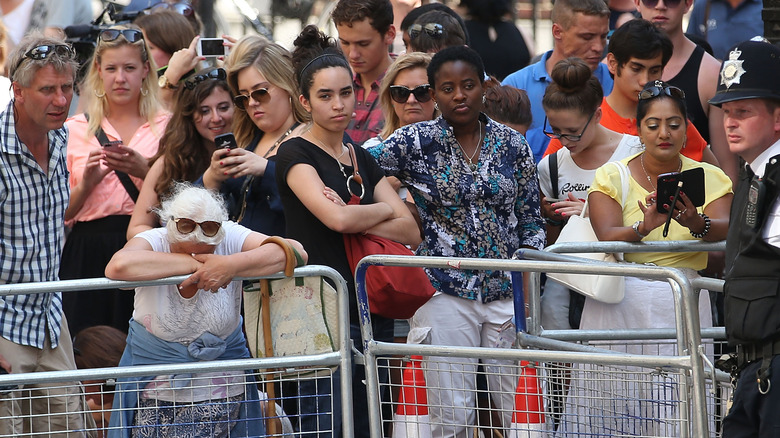 Spectators gather outside the hospital where a royal baby is born