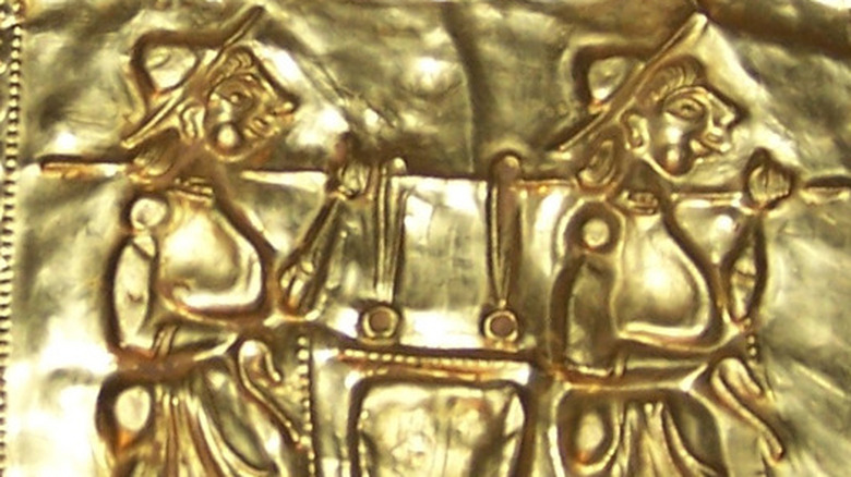 book of gold with engraved figures 