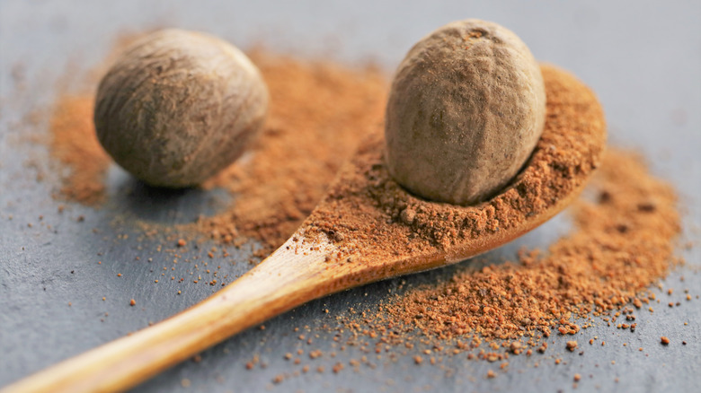 whole nutmeg ground on a spoon