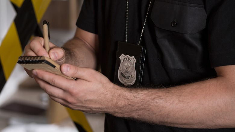 cop writing in a notebook