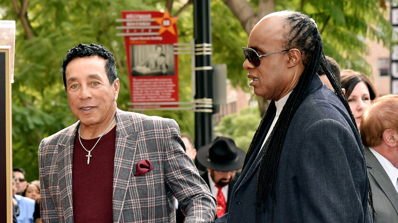 Smokey Robinson and Stevie Wonder standing