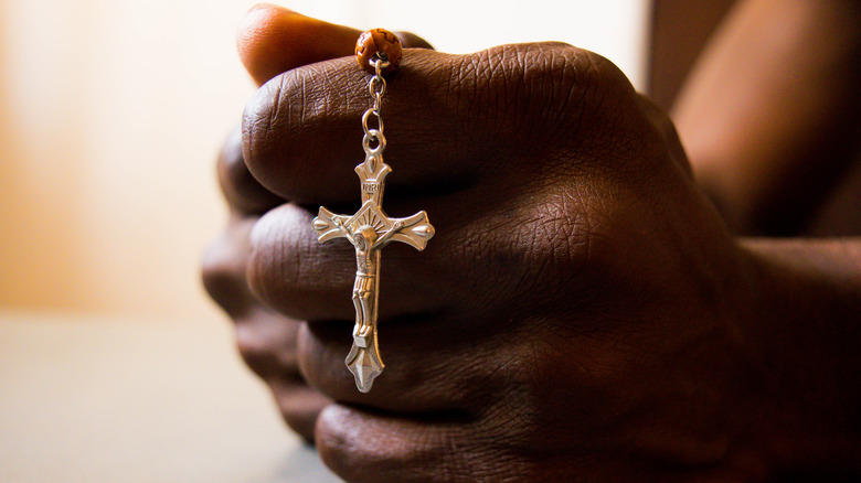 Hands holding cross in prayer