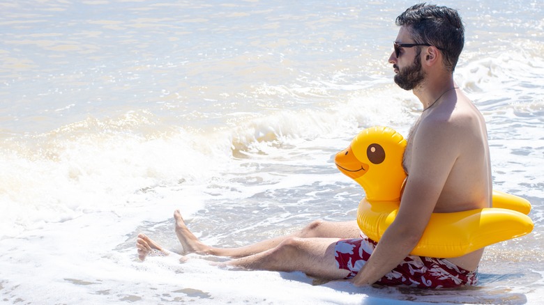 sad man sitting at the beach