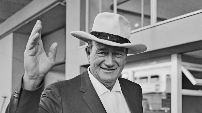 John Wayne in hat waving