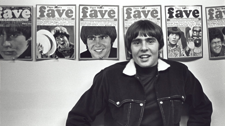 savy jones the monkees standing in front of magazine covers
