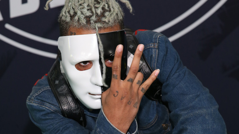 XXXTentacion posing in a black and white mask