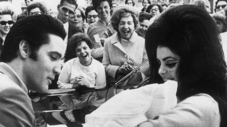 Elvis Presley with wife Priscilla and baby Lisa Marie