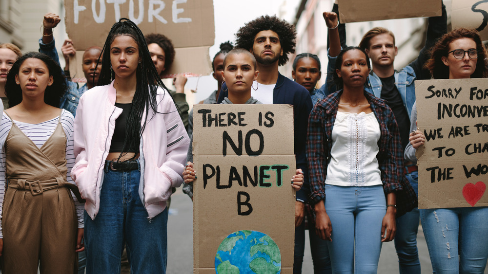 Climate protestors holding signs