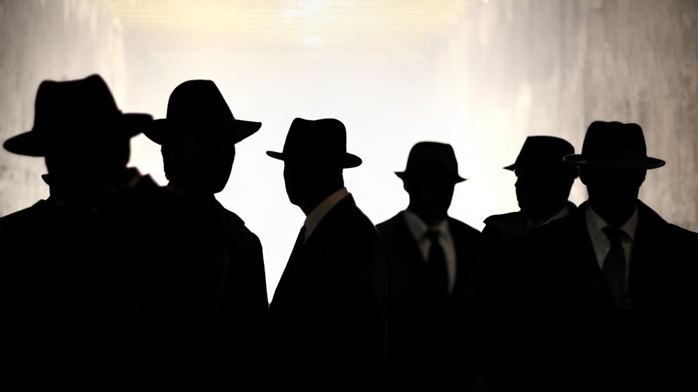 An artist's rendition of spies, featuring fedora-wearing silhouettes