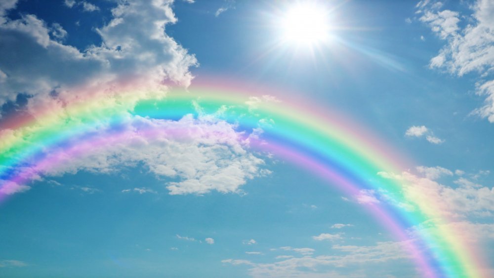 A picture of a vibrant rainbow on a bright day.