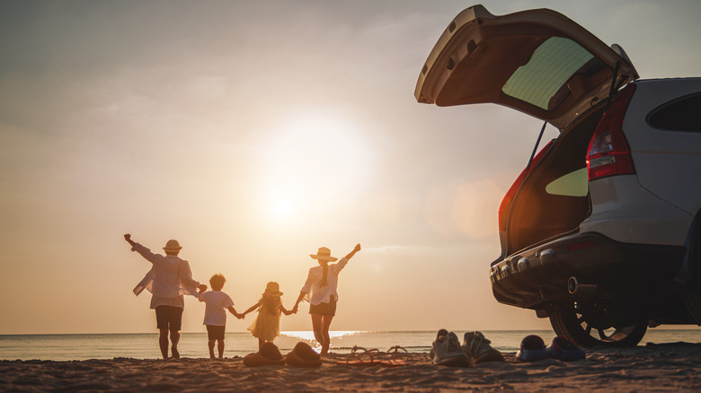 Family celebrating sunset on beach