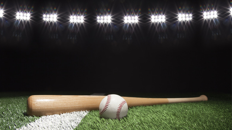 Ball and bat under stadium lights