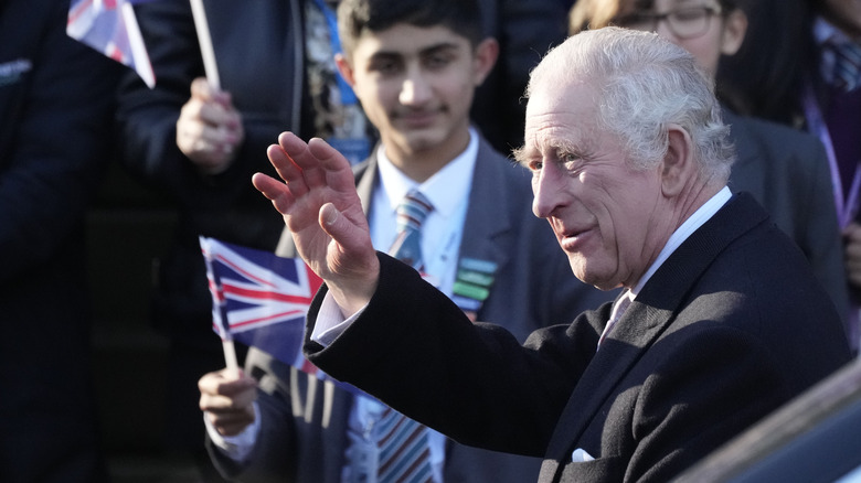 Charles III waves to well-wishers