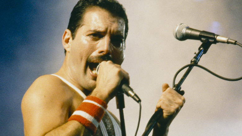 Freddie Mercury sings with two microphones