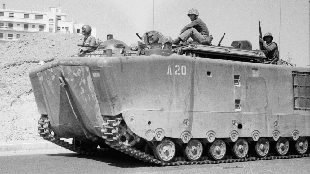 Marines riding on top of tank