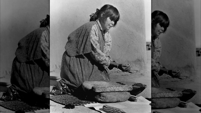 Pueblo woman grinding maize  