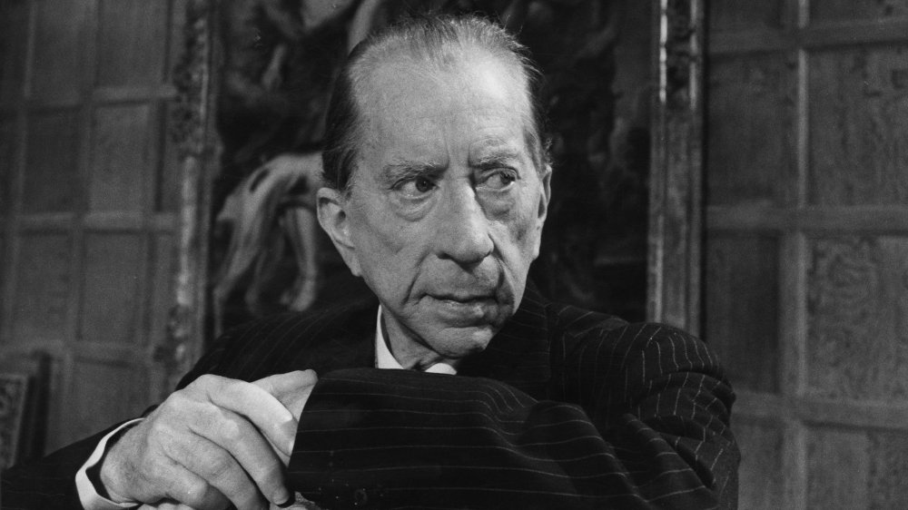 J. Paul Getty, hands leaning on the back of a chair