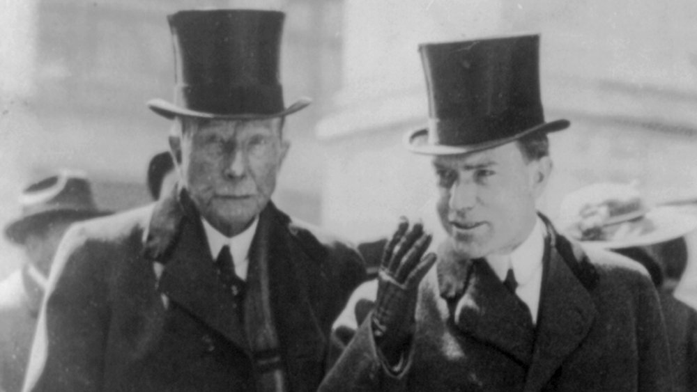 John D. Rockefeller with son, John D. Rockefeller Jr., on the street