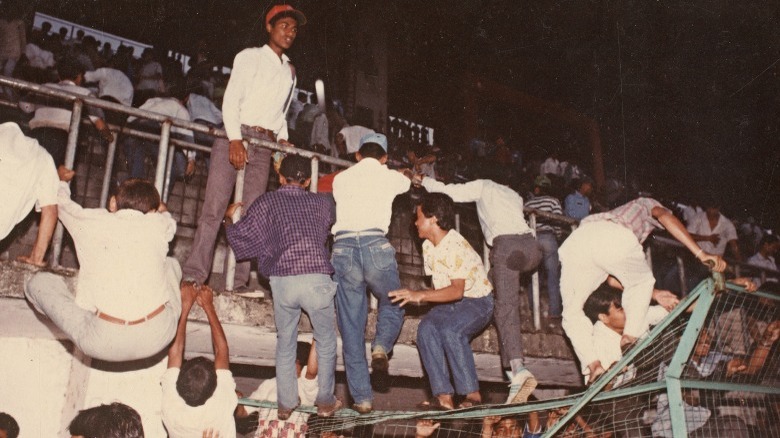 Fans climbing on dilapidated stands at Dasharath Stadium