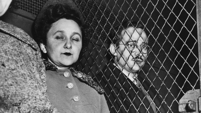 Ethel and Julius Rosenberg sit either side of fence 