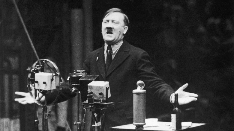 Adolf Hitler giving speech with microphones