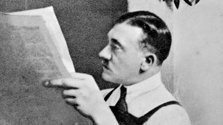 Hitler reading newspaper in prison