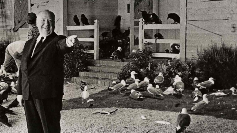 Alfred Hitchcock surrounded by birds