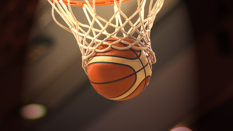 Basketball falling through the bottom of basketball hoop