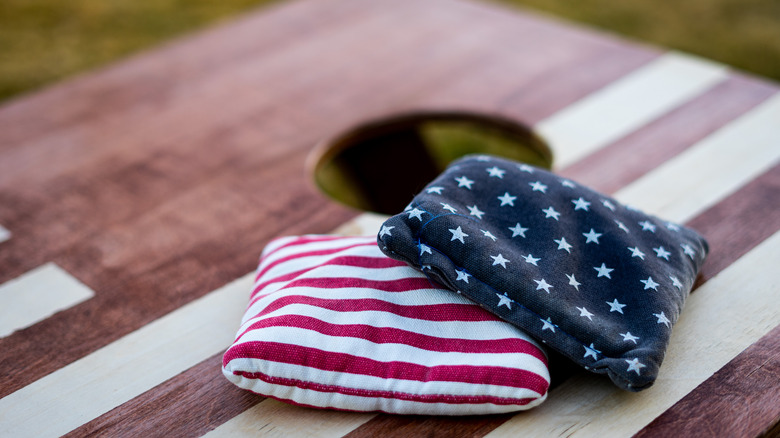 Two bags on cornhole platform