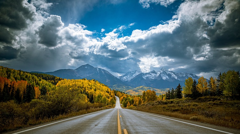 Colorado road under blue sky and clouds