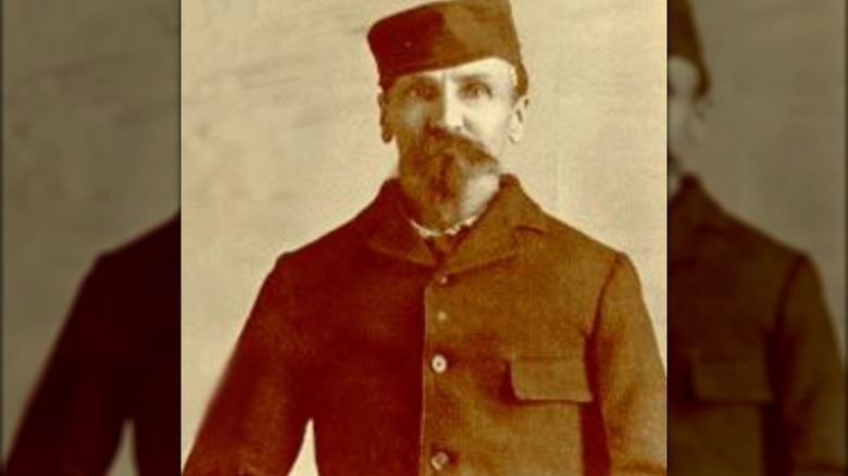 Alferd Packer in cap and coat