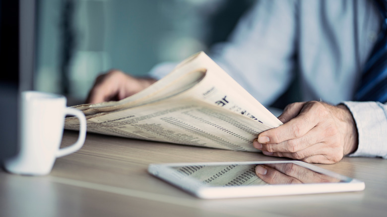 a person reading a newspaper