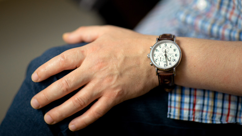 Man's hand wearing a watch