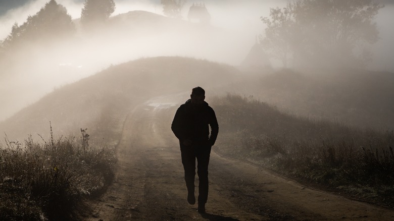 Man walking into fog