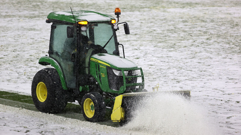 Snow plow clearing a field