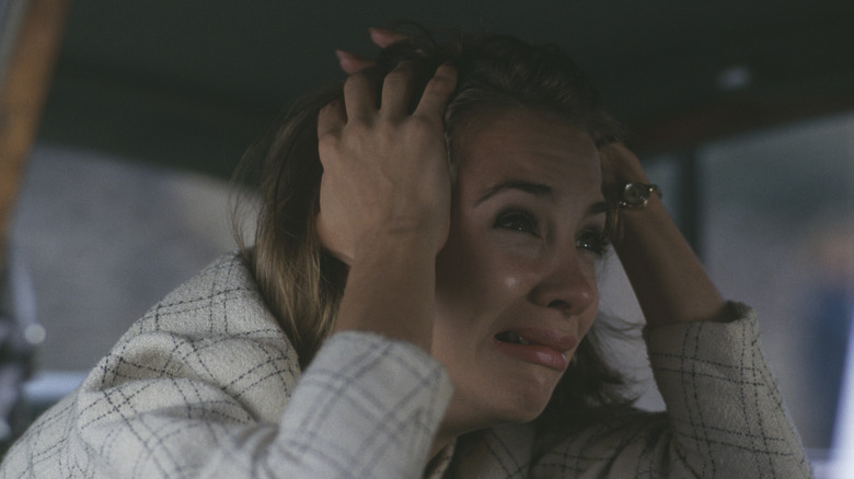 Actress in crying scene with hands on head