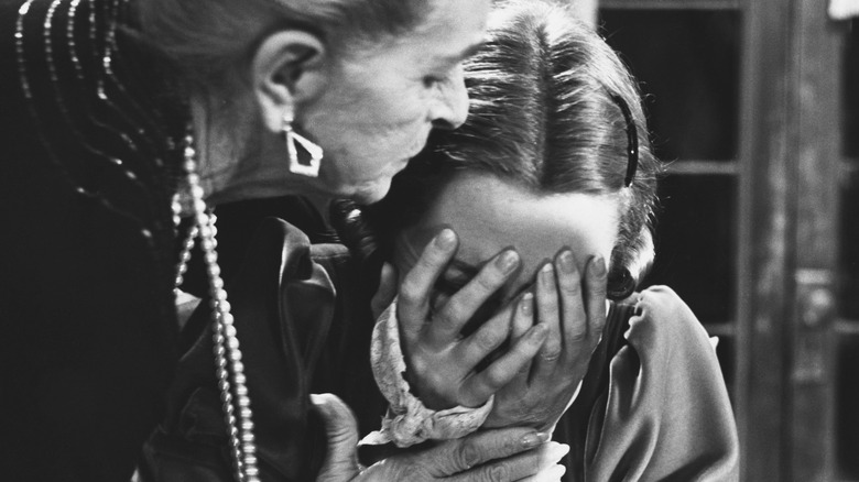 Older woman consoling young, crying woman