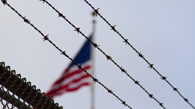 barbed wire, american flag, grey sky