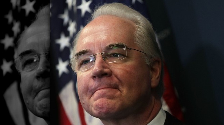 Tom Price glasses suit American flag behind him