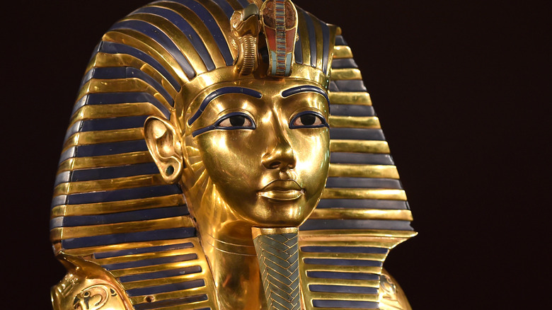 King Tut's burial mask against black