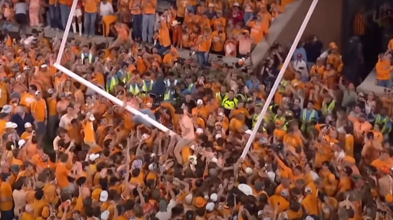 football fans tear down goalposts