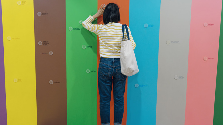 Lady at scratch-and-sniff wall