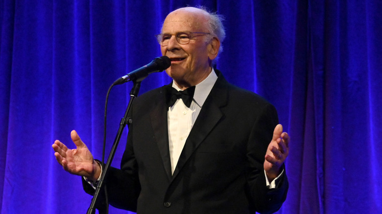 Art Garfunkel speaking into microphone on stage