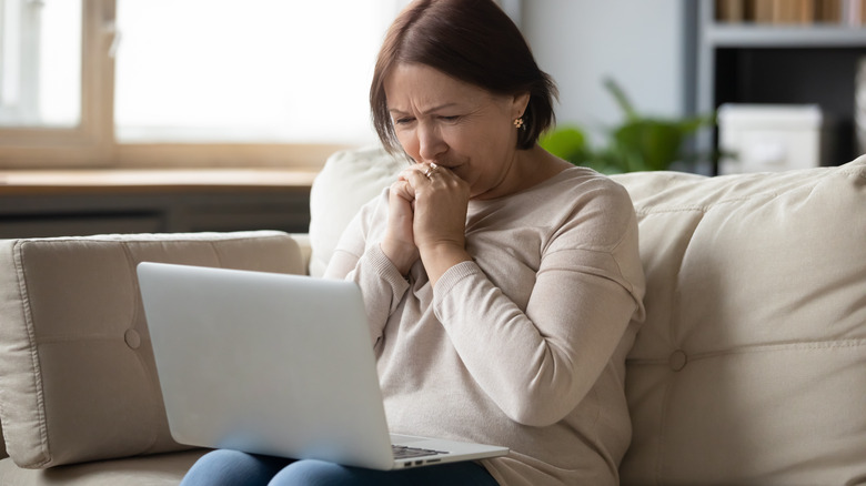 woman using the computer and crying grief