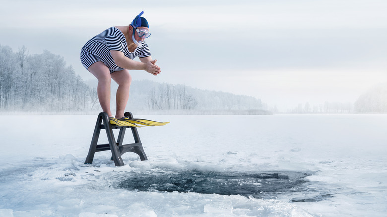 person jumping into freezing water