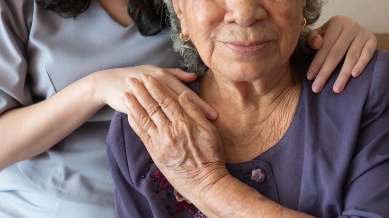 young person comforting an elderly friend