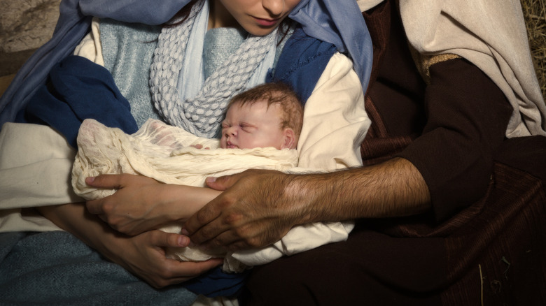 Mary and Joseph holding Jesus