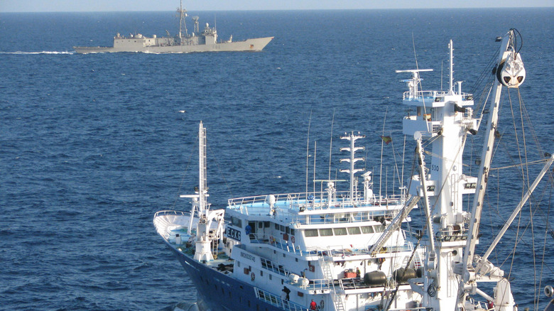 war ship protecting a vessel 